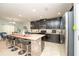 Modern kitchen with dark wood cabinets, granite countertops, and an island at 975 Benjamin Trl, Davenport, FL 33837