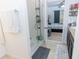 Large walk in shower with glass enclosure and multiple shelves at 975 Benjamin Trl, Davenport, FL 33837
