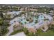 Community pool with water features and numerous lounge chairs at 1550 Observer Ln, Davenport, FL 33896