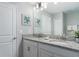 Double vanity bathroom with granite countertop and modern fixtures at 1550 Observer Ln, Davenport, FL 33896