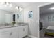 Bathroom with double vanity and access to bedroom at 1550 Observer Ln, Davenport, FL 33896