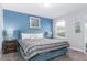 Serene bedroom with a teal bed and blue accent wall at 1550 Observer Ln, Davenport, FL 33896