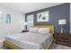 Bright bedroom with a plush bed and accent wall at 1550 Observer Ln, Davenport, FL 33896