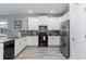 Modern kitchen with white cabinets and stainless steel appliances at 1550 Observer Ln, Davenport, FL 33896