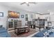Living room with blue couches and a large TV at 1550 Observer Ln, Davenport, FL 33896