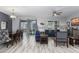 Open living and dining area with hardwood floors and access to patio at 1550 Observer Ln, Davenport, FL 33896
