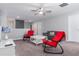 Upstairs loft area with red rocking chairs and a gray couch at 1550 Observer Ln, Davenport, FL 33896