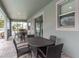 Covered patio with wicker furniture and a view of the backyard at 1550 Observer Ln, Davenport, FL 33896