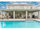 Large, screened pool with plenty of patio furniture at 1550 Observer Ln, Davenport, FL 33896
