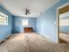 Light blue bedroom with ceiling fan and window at 1733 Hickorywood Ln, Orlando, FL 32818