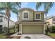 Two-story house with a green exterior, attached garage, and landscaping at 1912 Portcastle Cir, Winter Garden, FL 34787