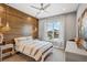 Cozy bedroom with wood accent wall, large window and striped bedding at 2205 Lake Sylvan Oaks Ct, Sanford, FL 32771