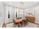 Elegant dining room with hardwood floors, large windows, and a modern chandelier at 2205 Lake Sylvan Oaks Ct, Sanford, FL 32771