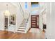 Modern entryway with a stunning staircase, high ceilings, and natural light at 2205 Lake Sylvan Oaks Ct, Sanford, FL 32771