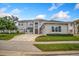 Two-story house with stone exterior, paver driveway and landscaping at 2205 Lake Sylvan Oaks Ct, Sanford, FL 32771