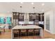 Modern kitchen with large island, stainless steel appliances, and dark cabinetry at 2205 Lake Sylvan Oaks Ct, Sanford, FL 32771
