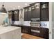 Gourmet kitchen featuring stainless steel appliances and dark wood cabinetry at 2205 Lake Sylvan Oaks Ct, Sanford, FL 32771