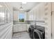 Spacious laundry room with modern appliances and gray striped walls at 2205 Lake Sylvan Oaks Ct, Sanford, FL 32771