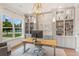 Home office with built-in shelving, large window, and hardwood floors at 2205 Lake Sylvan Oaks Ct, Sanford, FL 32771