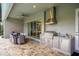 Outdoor kitchen with stainless steel appliances and seating area at 2205 Lake Sylvan Oaks Ct, Sanford, FL 32771