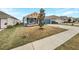New construction home with blue siding, two-car garage and small front yard at 225 Arbuthnot St, Winter Haven, FL 33881