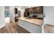 Modern kitchen with island, stainless steel appliances, and wood flooring at 225 Arbuthnot St, Winter Haven, FL 33881