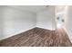 Bright living room with wood-look floors and access to other rooms at 225 Arbuthnot St, Winter Haven, FL 33881