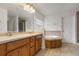 Double vanity bathroom with large mirror and tile flooring at 2806 Balforn Tower Way, Winter Garden, FL 34787