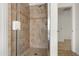 Large tiled shower with glass enclosure and neutral tones at 2806 Balforn Tower Way, Winter Garden, FL 34787