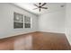 Spacious bedroom with hardwood floors and large window at 2806 Balforn Tower Way, Winter Garden, FL 34787