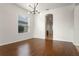 Spacious dining room with hardwood floors and view into kitchen at 2806 Balforn Tower Way, Winter Garden, FL 34787