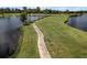 Landscaped golf course with a path next to the water at 2806 Balforn Tower Way, Winter Garden, FL 34787