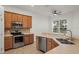 Kitchen features stainless steel appliances and wood cabinets at 2806 Balforn Tower Way, Winter Garden, FL 34787