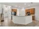 Kitchen with wood cabinets, stainless steel appliances, and an island at 2806 Balforn Tower Way, Winter Garden, FL 34787
