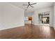 Bright living room with hardwood floors and sliding glass doors leading to a patio at 2806 Balforn Tower Way, Winter Garden, FL 34787