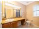 Clean bathroom with granite vanity and a toilet at 3030 Calabria Ave # 436, Davenport, FL 33897