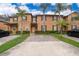 Tan two-story townhome with palm trees and brick driveway at 3030 Calabria Ave # 436, Davenport, FL 33897