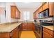 Galley kitchen with granite countertops and stainless steel appliances at 3030 Calabria Ave # 436, Davenport, FL 33897