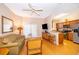 Open living room with kitchen, wood floors and wicker furniture at 3030 Calabria Ave # 436, Davenport, FL 33897