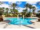 Resort-style pool with lounge chairs and palm trees at 3030 Calabria Ave # 436, Davenport, FL 33897