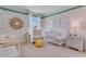 Charming Bedroom with crib, armchair, and window at 3535 Sandalwood Isle Way, Ocoee, FL 34761