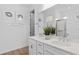 Double vanity bathroom with modern fixtures and a large mirror at 4023 Meandering Bay Dr, Apopka, FL 32712