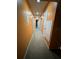 Orange hallway with carpeted floors and neutral doors at 4136 Versailles Dr # 4136D, Orlando, FL 32808