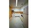 Galley kitchen with white cabinets and orange walls at 4136 Versailles Dr # 4136D, Orlando, FL 32808