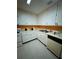 Galley kitchen with white cabinets and orange walls at 4136 Versailles Dr # 4136D, Orlando, FL 32808
