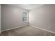 Simple bedroom with carpeted floor and a window at 6292 Twain St # 101, Orlando, FL 32835