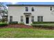 Rear view of the townhome, showing a private backyard and manicured landscaping at 6292 Twain St # 101, Orlando, FL 32835