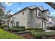 Two-story townhome showcasing its side profile and neatly landscaped yard at 6292 Twain St # 101, Orlando, FL 32835