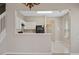 Open kitchen with white cabinets, black appliances, and a breakfast bar at 6292 Twain St # 101, Orlando, FL 32835