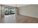 Living room with hardwood floors and sliding glass doors leading to a screened patio at 6292 Twain St # 101, Orlando, FL 32835